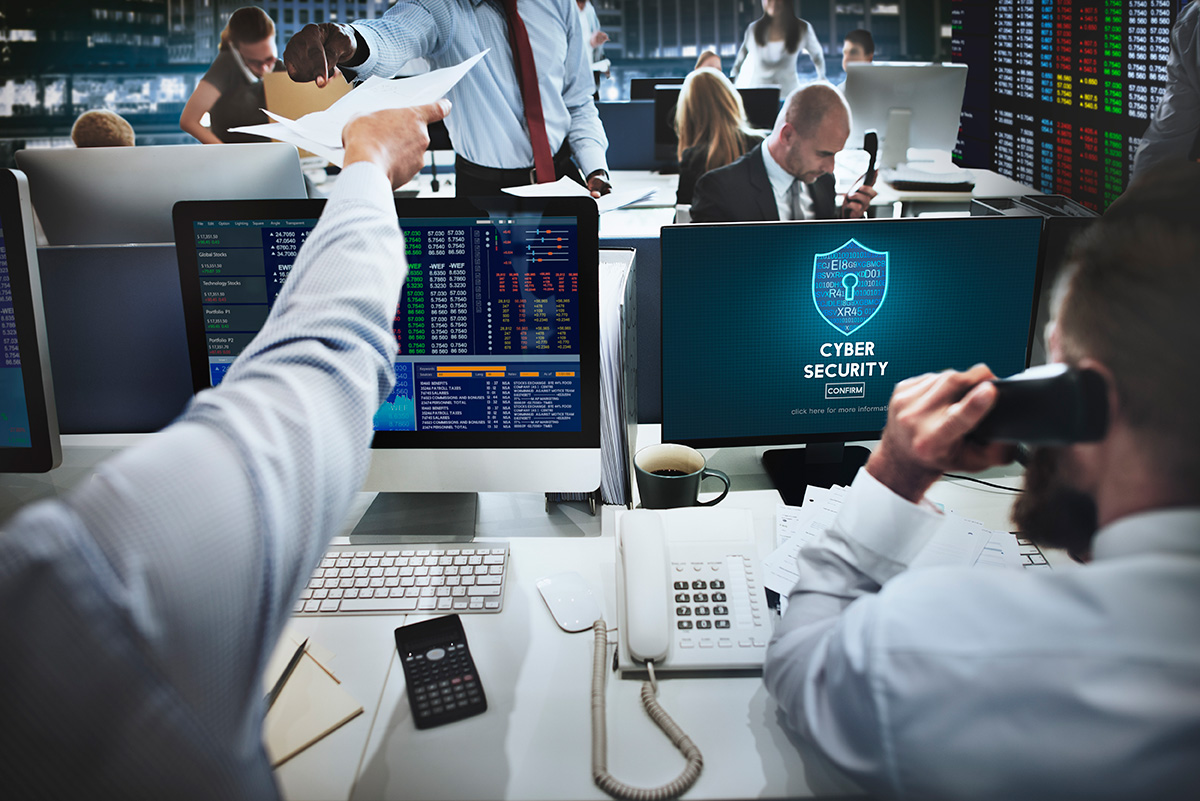 A busy healthcare center with IT professionals monitoring patient data and network security on multiple screens.